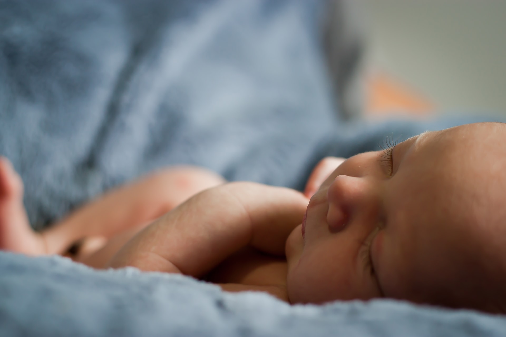 A newborn baby on a blue blanket